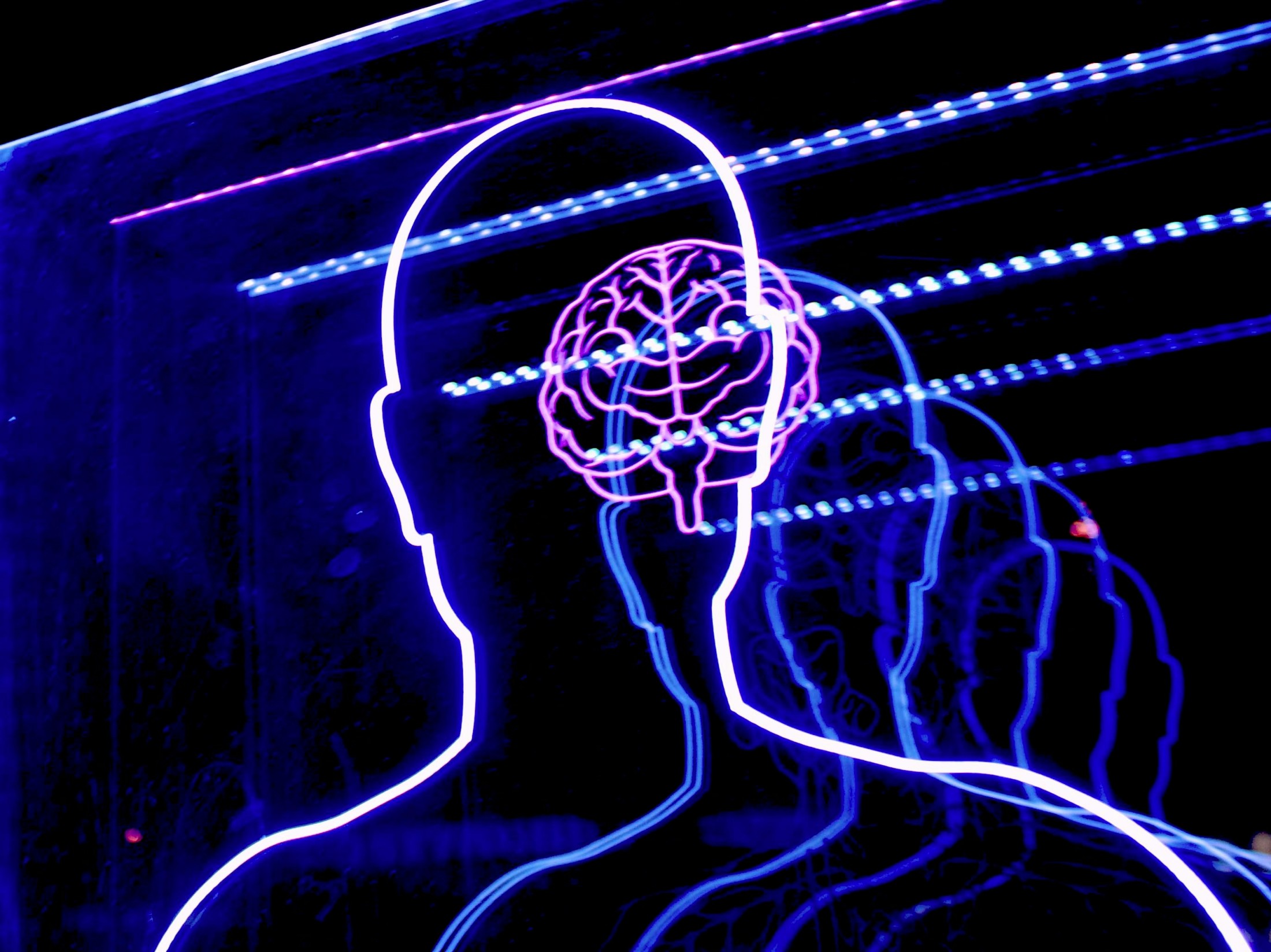 Outline of a person and a digital brain as Anthropic provides a more detailed look into the complex inner workings of their advanced language model Claude to demystify how these sophisticated AI systems process information, learn strategies, and ultimately generate human-like text.